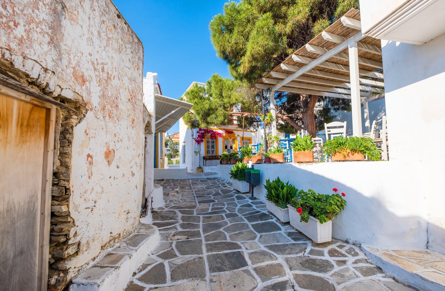 A narrow street with stone houses in Lefkes, Paros