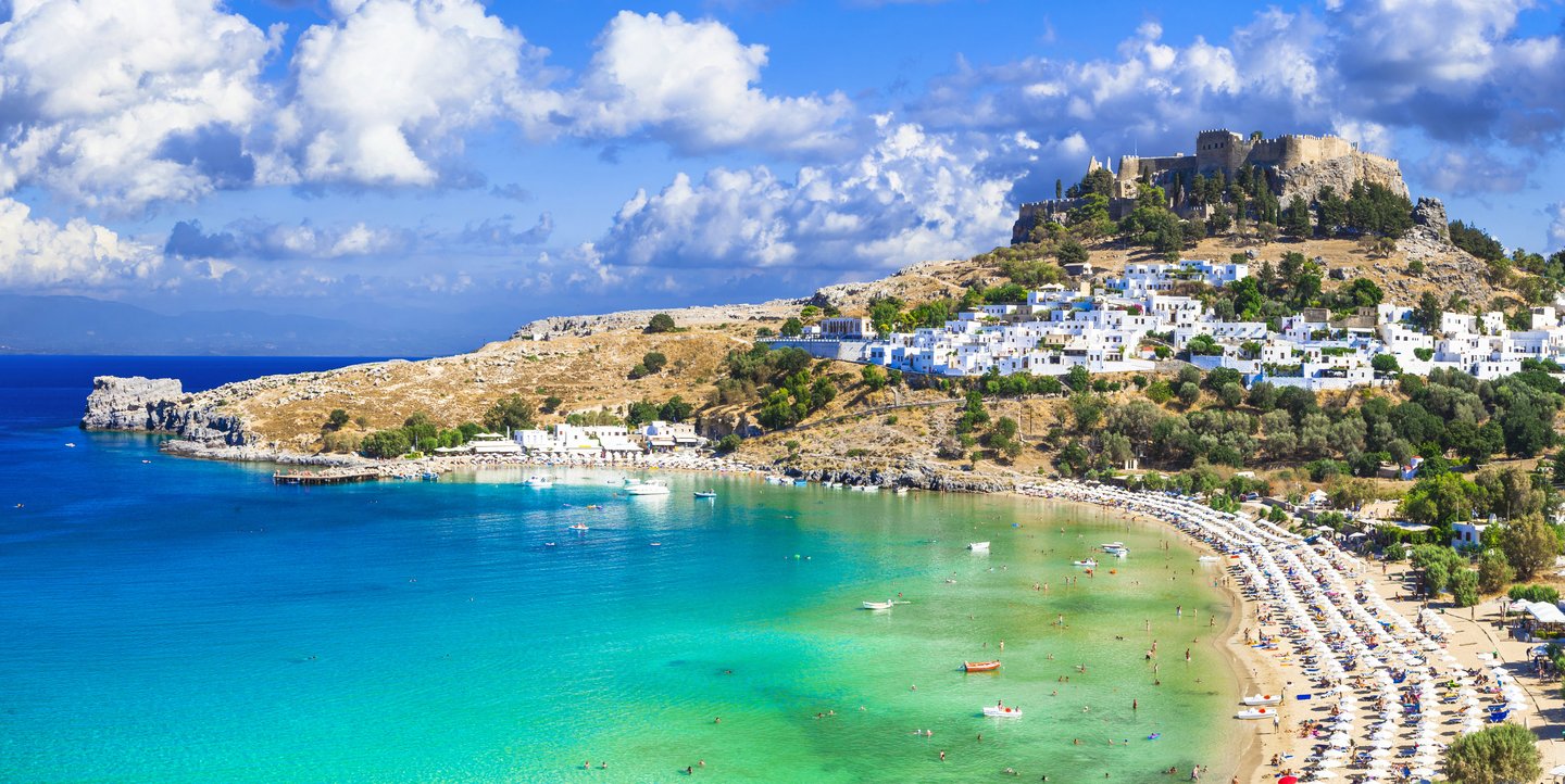 Panoramic view of Lindos bay, village and Acropolis in Rhodes, Greece.