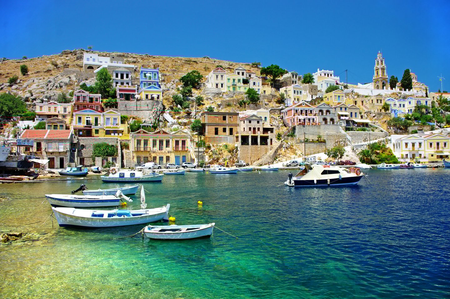 Boats and colourful houses at Symi Island, Greece.