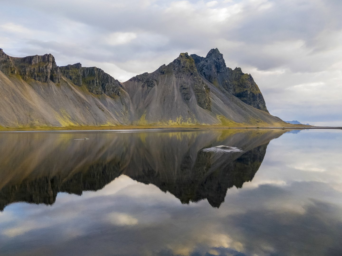 Beautiful view of mountains reflected in a lake in Hofn, Iceland