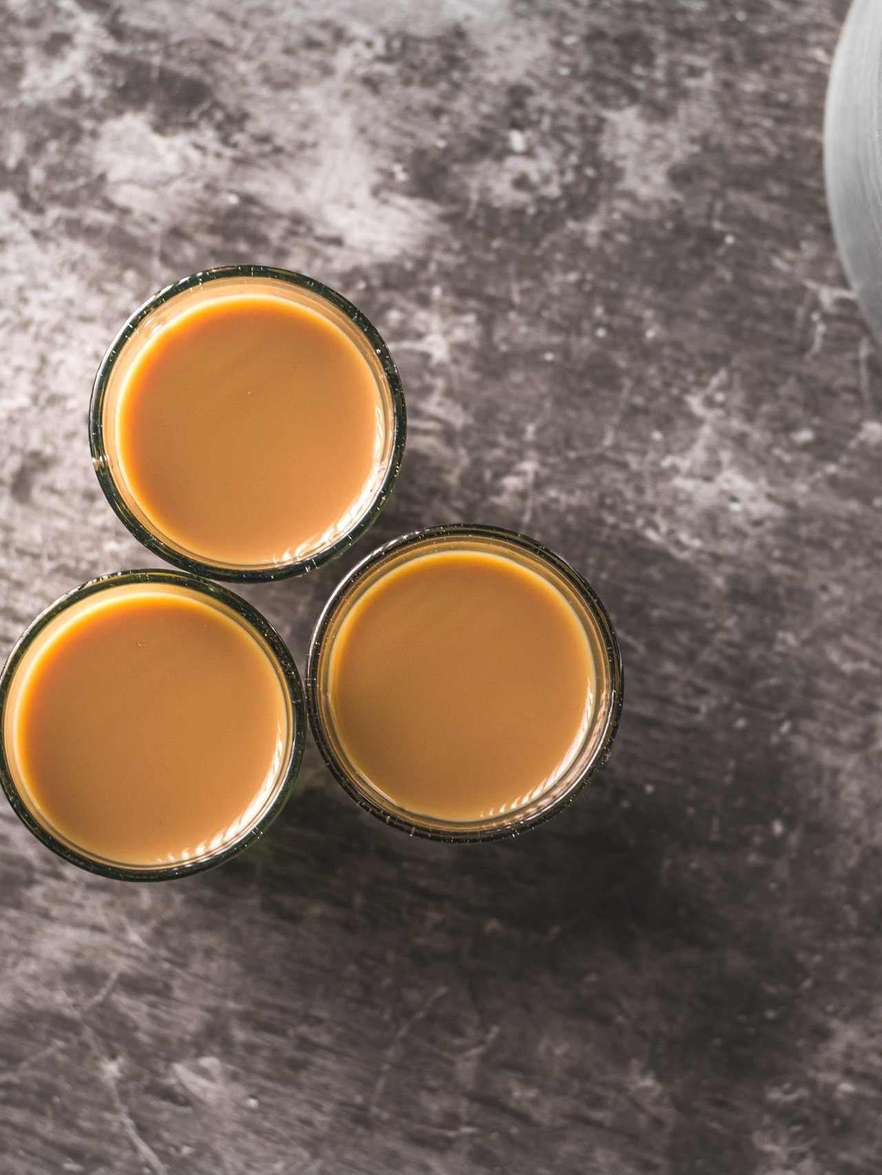 Spiced Indian tea in glass cups with a metal kettle 