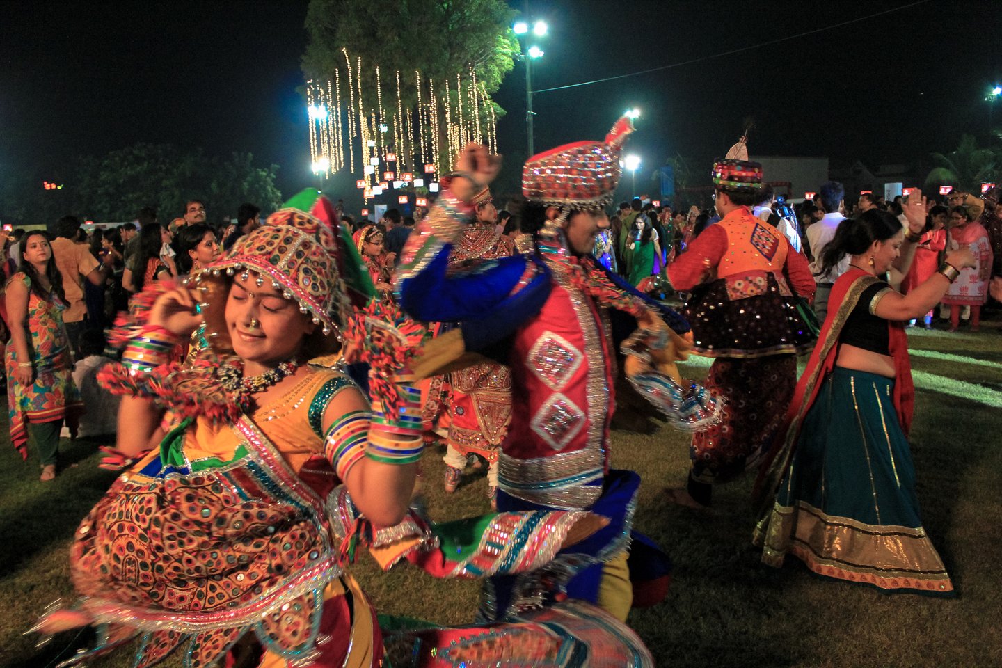 People celebrating Navratri Festival in Gujarat, India wearing traditional costume.