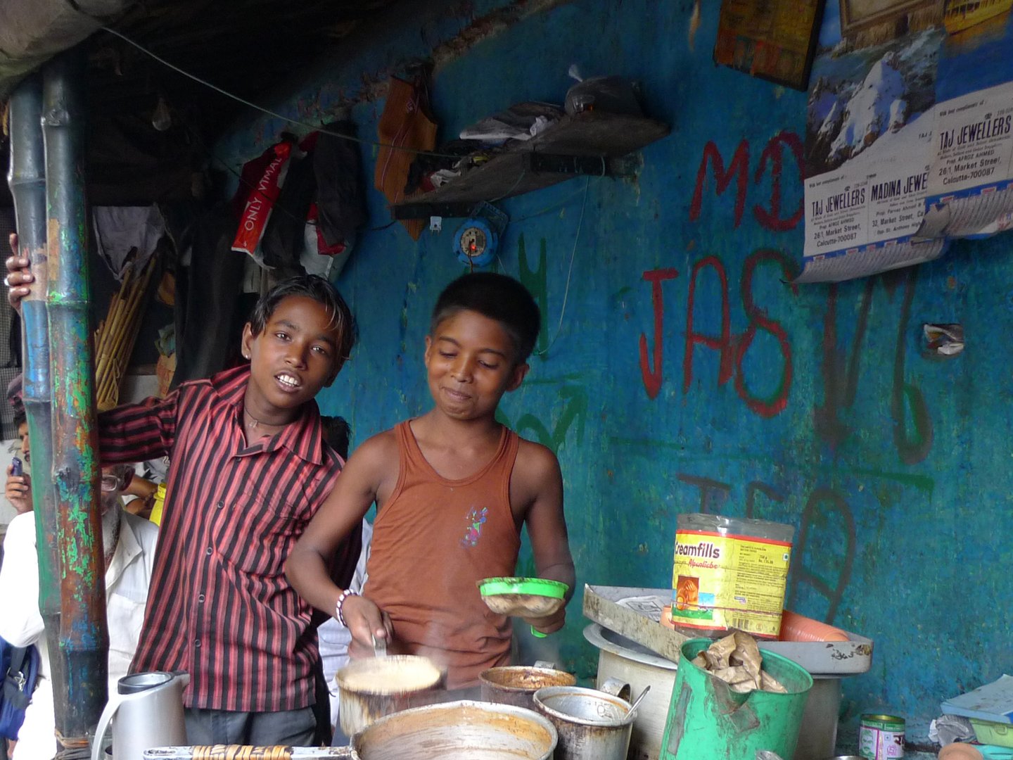 Children making tea at a tea bar in Kolkata, India.