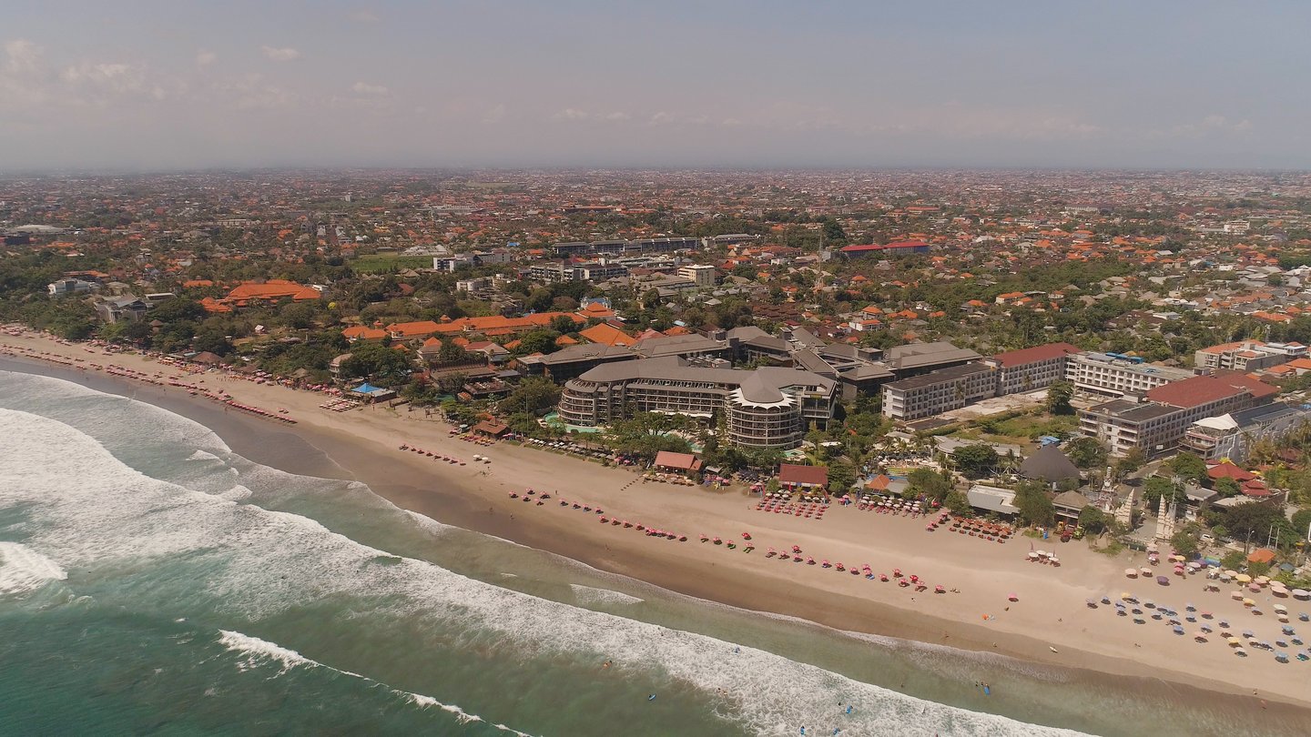 An aerial view of resorts and loungers on Kuta Beach