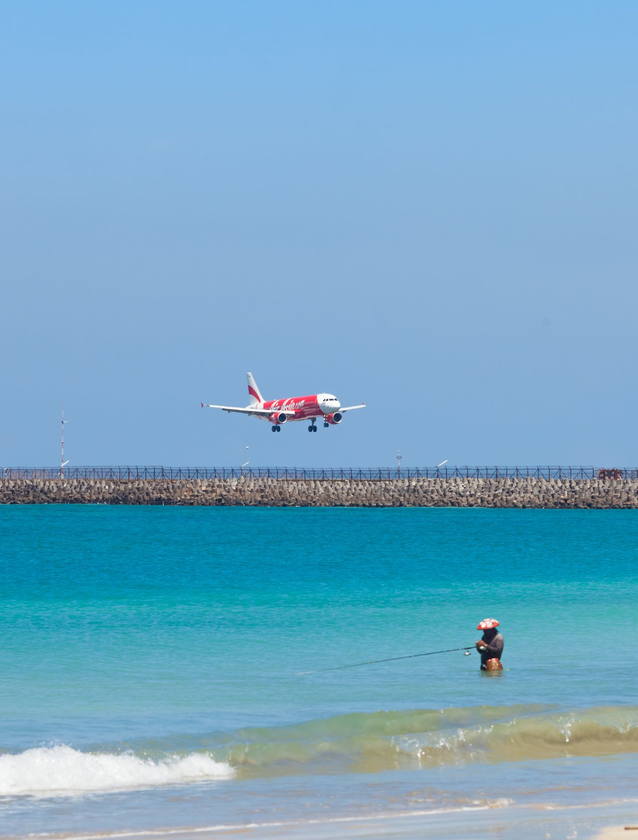 A plane flying over a beach in Bali, Indonesia.