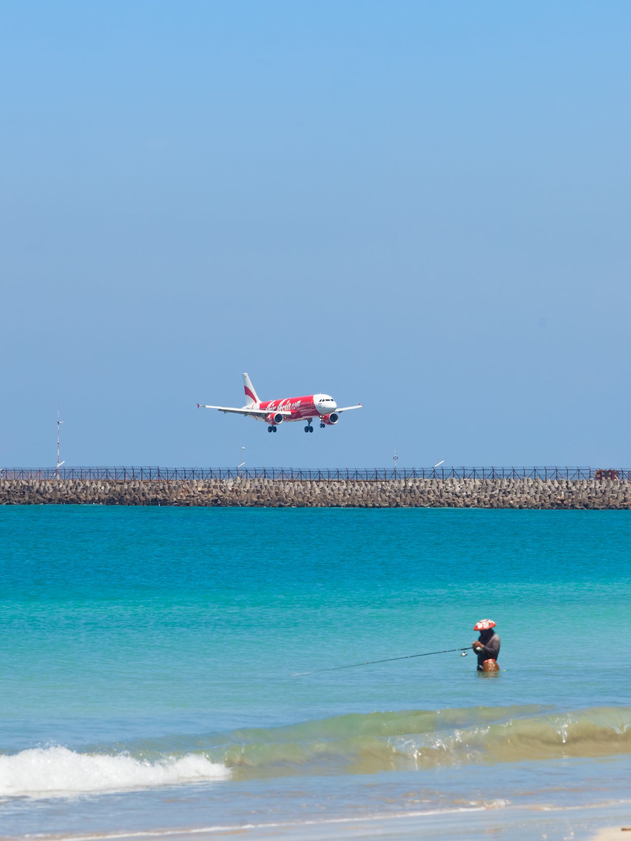 A plane flying over a beach in Bali, Indonesia.