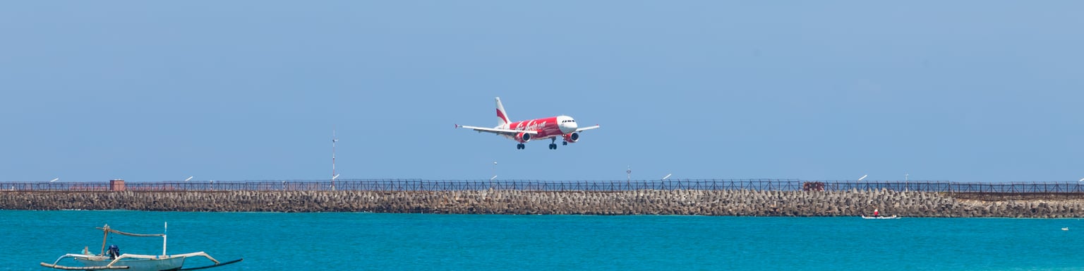 A plane flying over a beach in Bali, Indonesia.