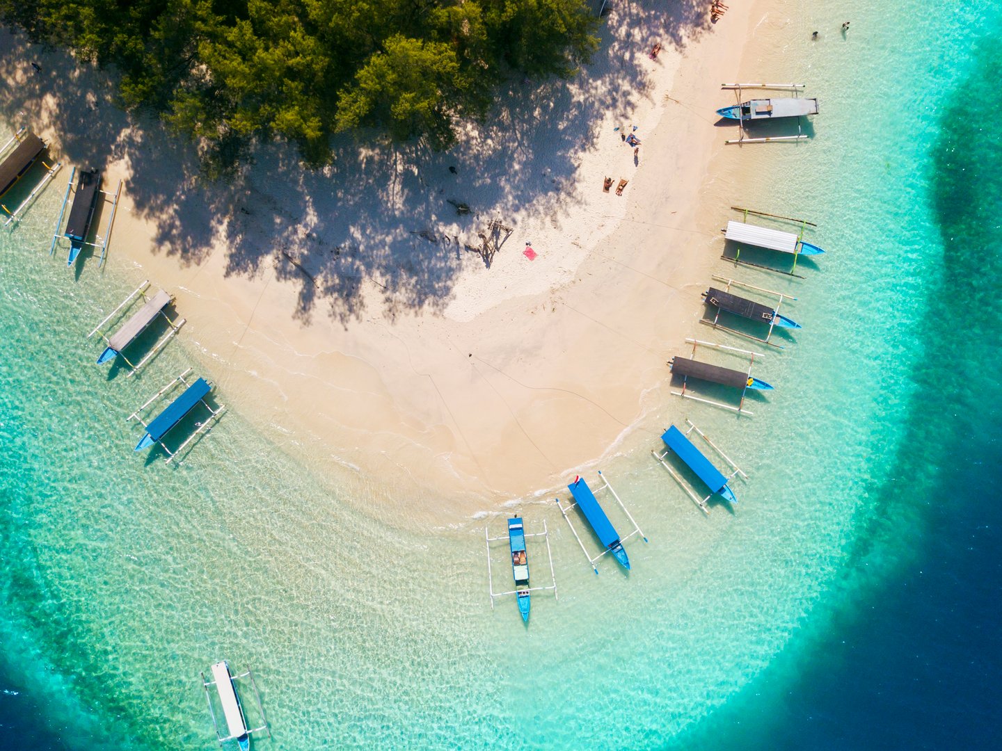 An aerial view of traditional boats moored around Gili Nanggu, Indonesia