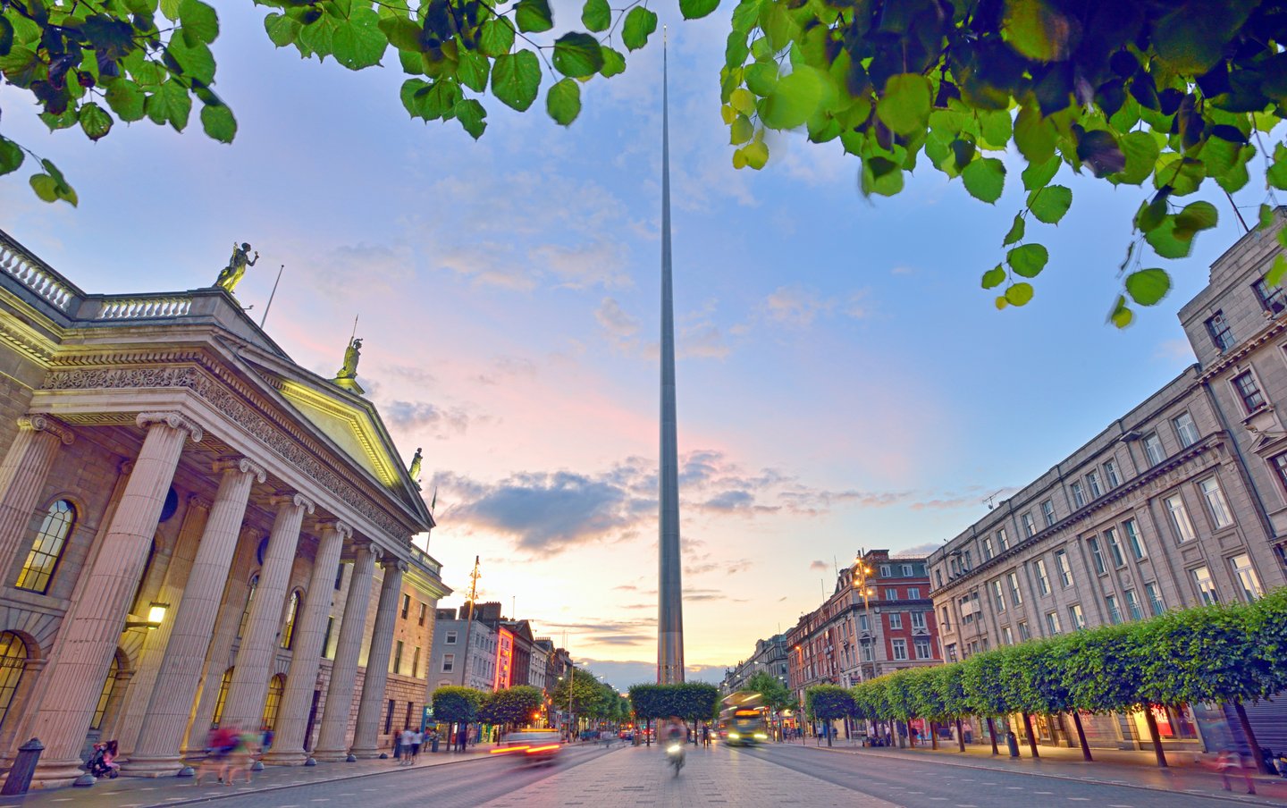 Dublin's spire dominating the street at sunset
