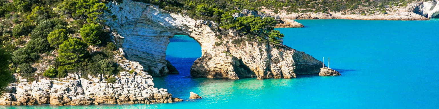 The rocky coastline and blue waters of Gargano National Park in Puglia, Italy