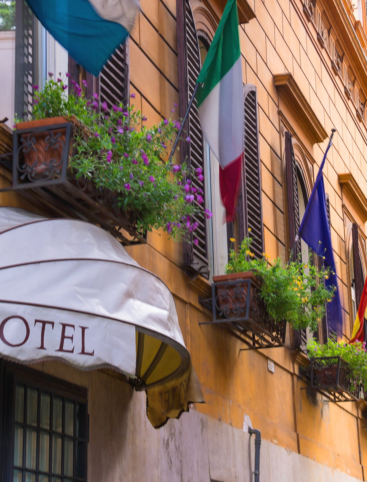 Flags displayed outside a hotel in Italy.