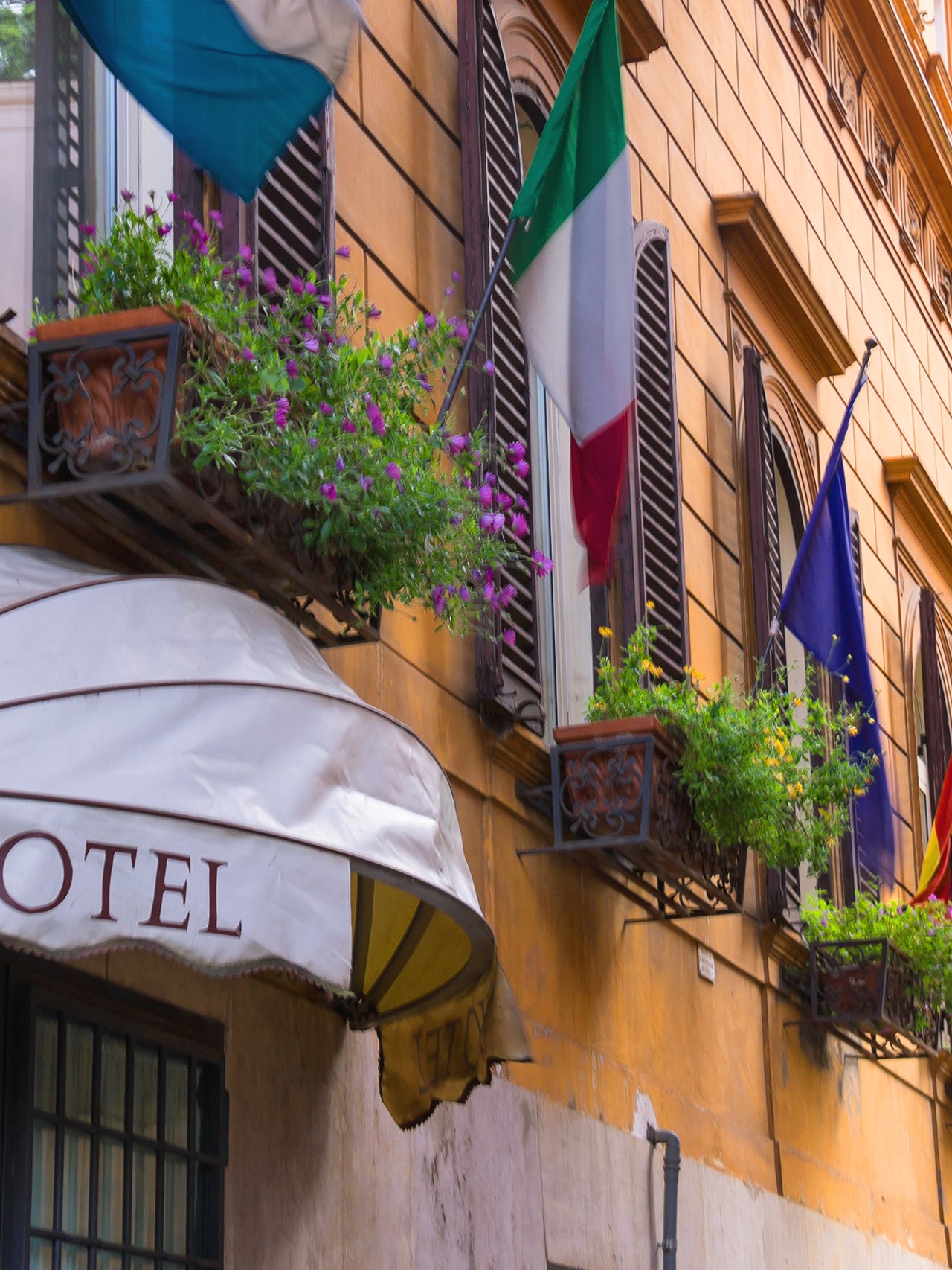 Flags displayed outside a hotel in Italy.