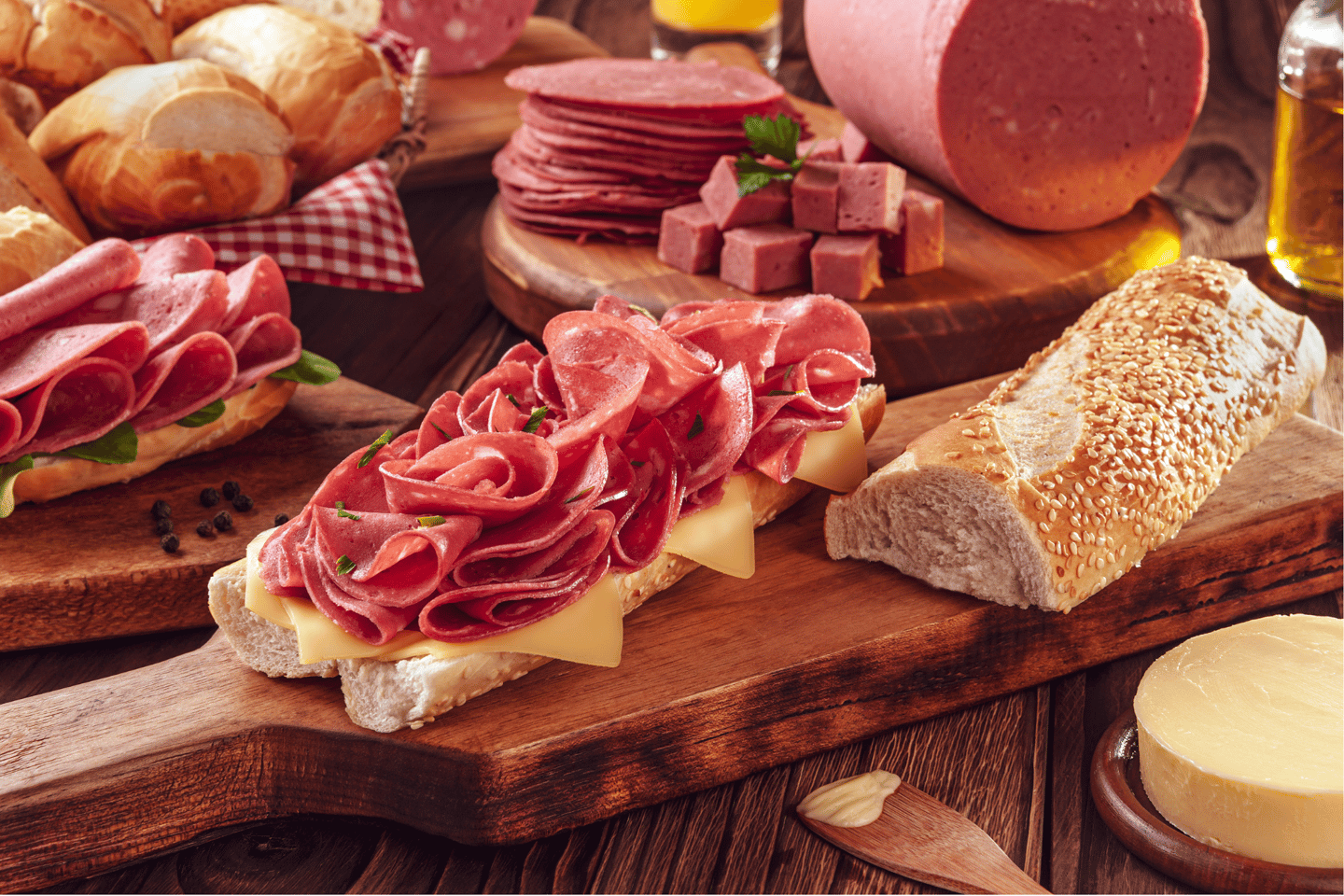 Mortadella sandwich with butter, bread and spices on wood cutting board