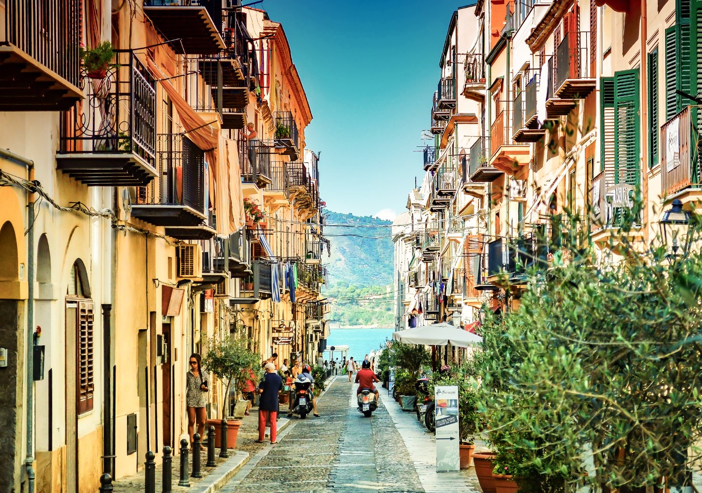 Colourful buildings along a street in Cefalu, Italy.