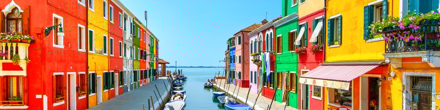 Colourful houses along a canal in Burano, Venice.