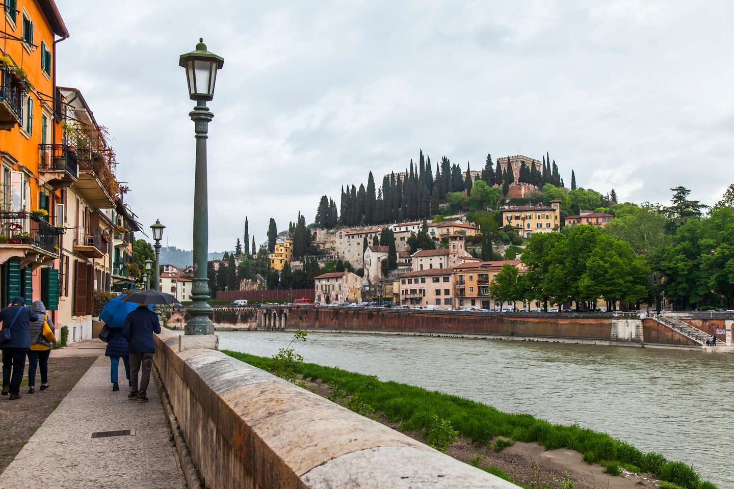 Walking along the Adige River on a grey day