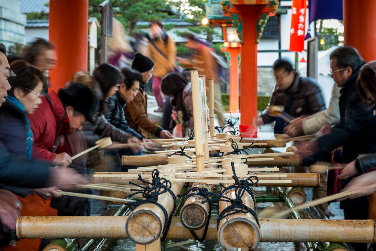 Japanese people purify their hands and mouths with water before entering Fushimi Inari Shrine on New Year's Day.