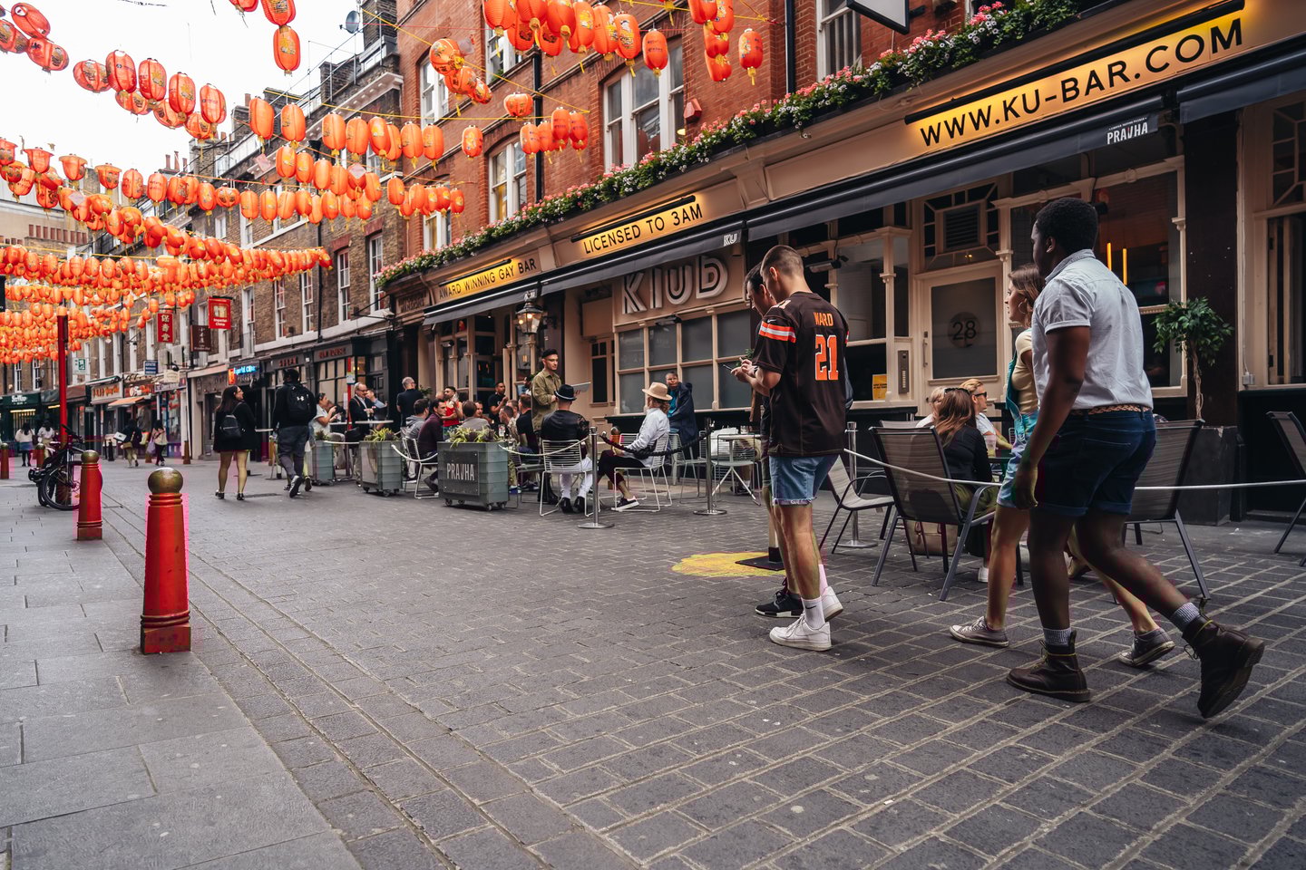 People walking down the street in Soho, London