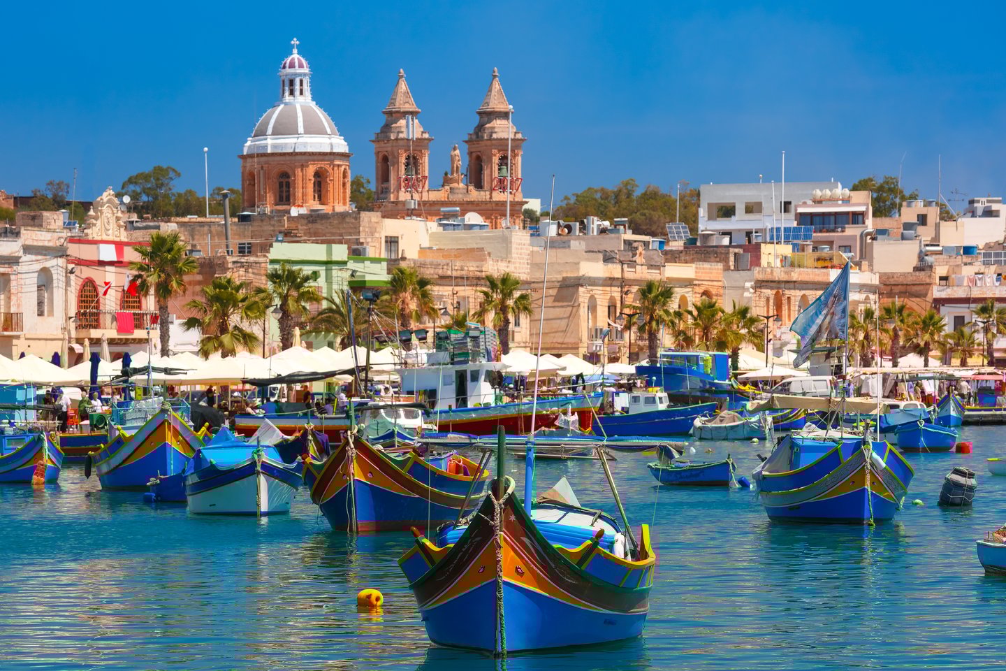Colourful, traditional fishing boats called Luzzu in Marsaxlokk, Malta
