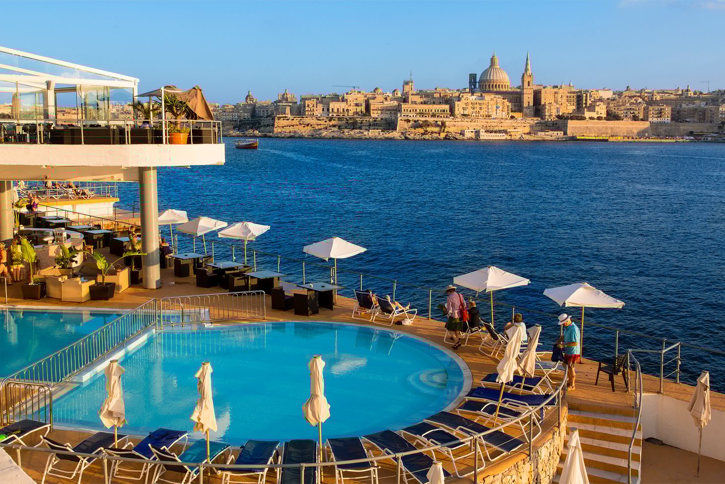 A hotel swimming pool in Sliema with view of Valletta in the distance