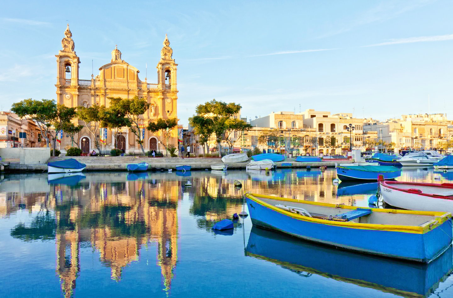 Boats in the harbour at Valletta with historic buildings in the background