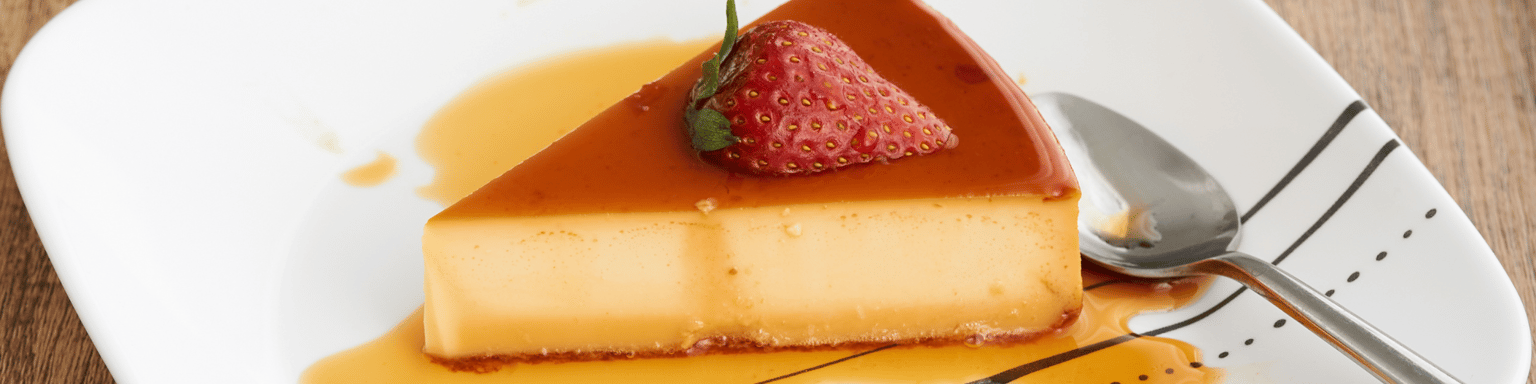 Slice of Mexican flan topped with a strawberry