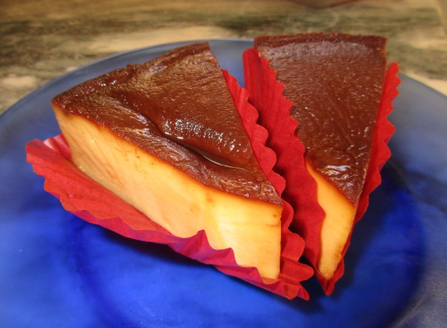 Two pieces of Mexican flan on a plate