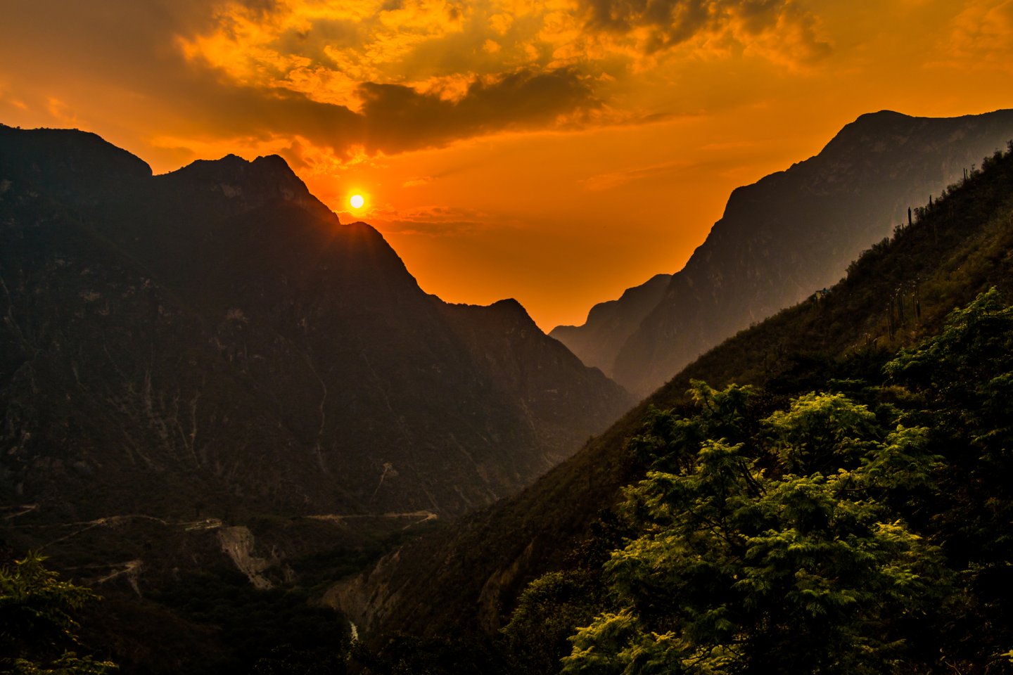 A red sunset over the mountains at Grutas de Tolantongo in Mexico