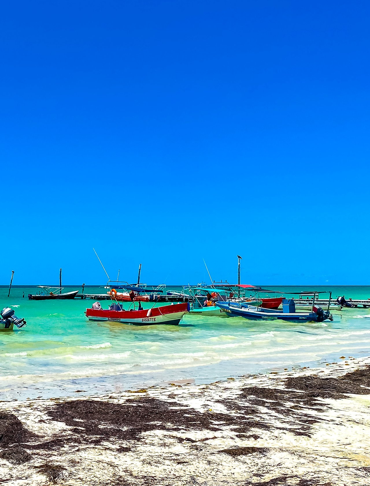 Colourful boats on the water in Holbox, Mexico