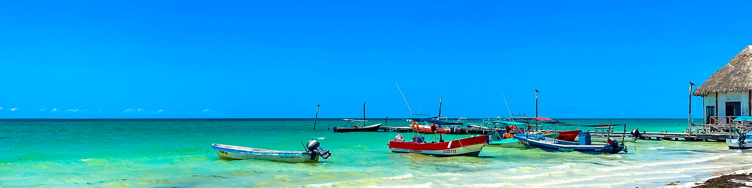 Colourful boats on the water in Holbox, Mexico