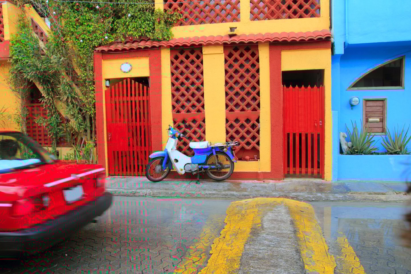 A scooter outside colourful buildings on Isla Mujeres, Mexico