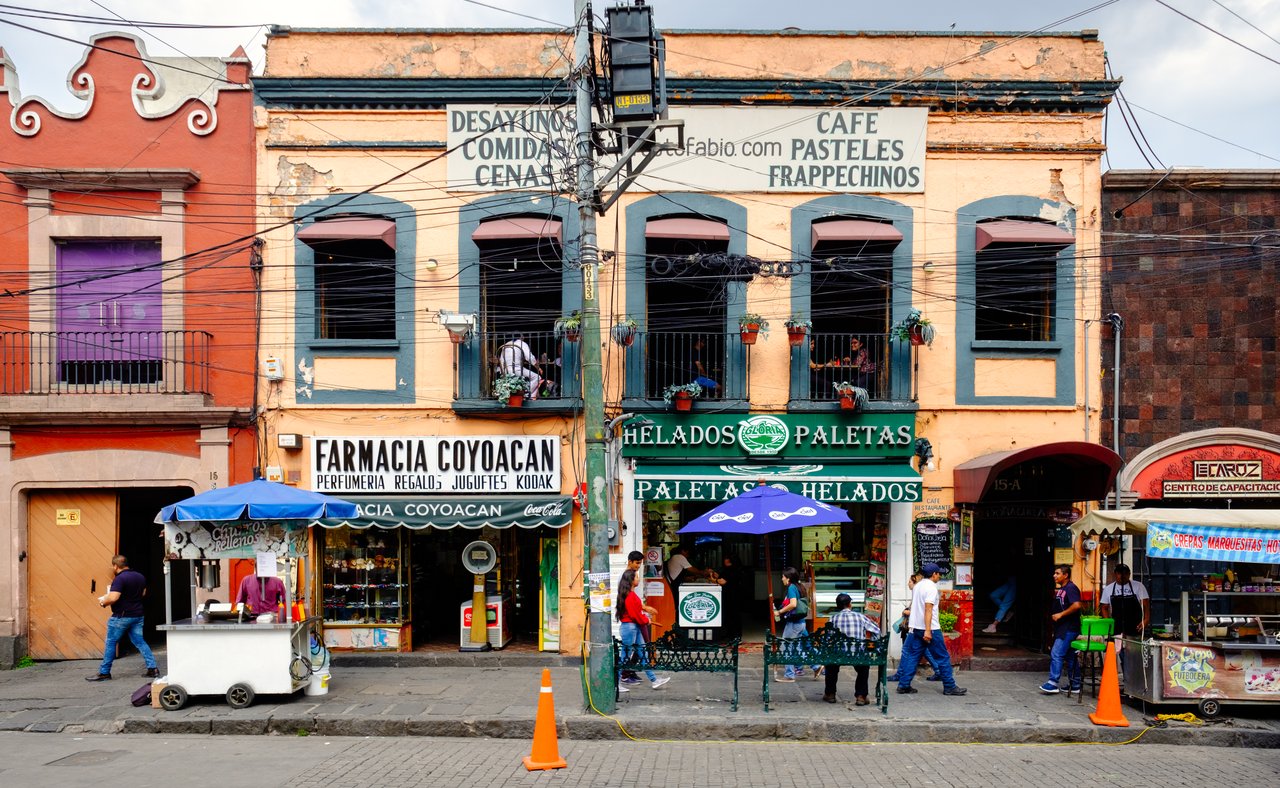 Local businesses at a colourful colonial building in Coyoacan, a historic neighbourhod in Mexico City.