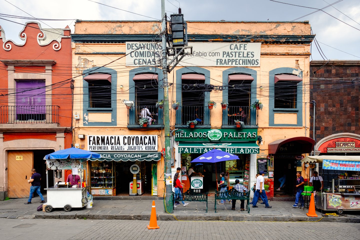 Local businesses at a colourful colonial building in Coyoacan, a historic neighbourhod in Mexico City.