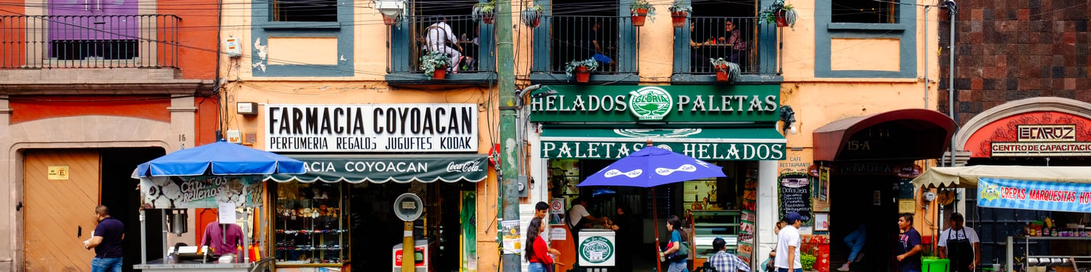 Local businesses at a colourful colonial building in Coyoacan, a historic neighbourhod in Mexico City.
