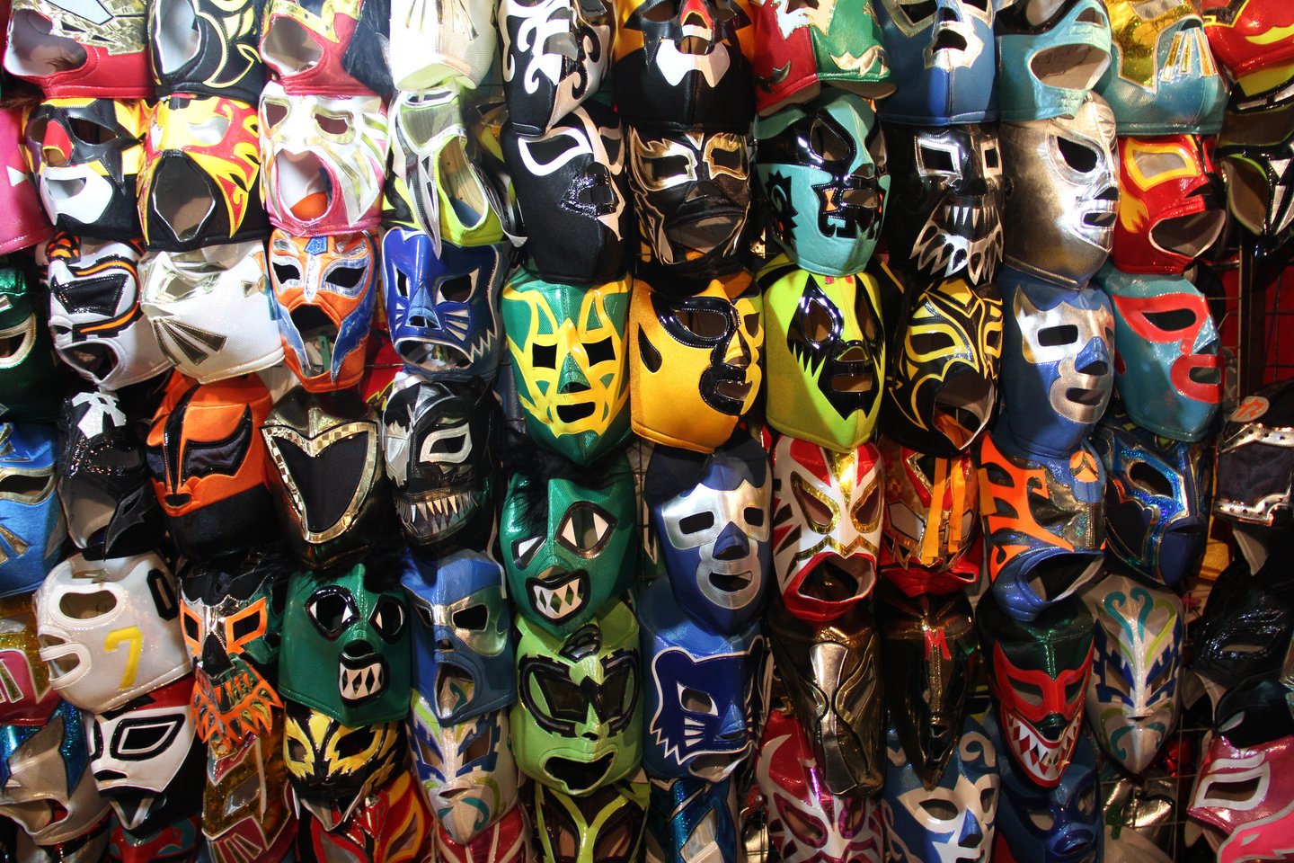 A wall of luchador masks at the market outside the arena