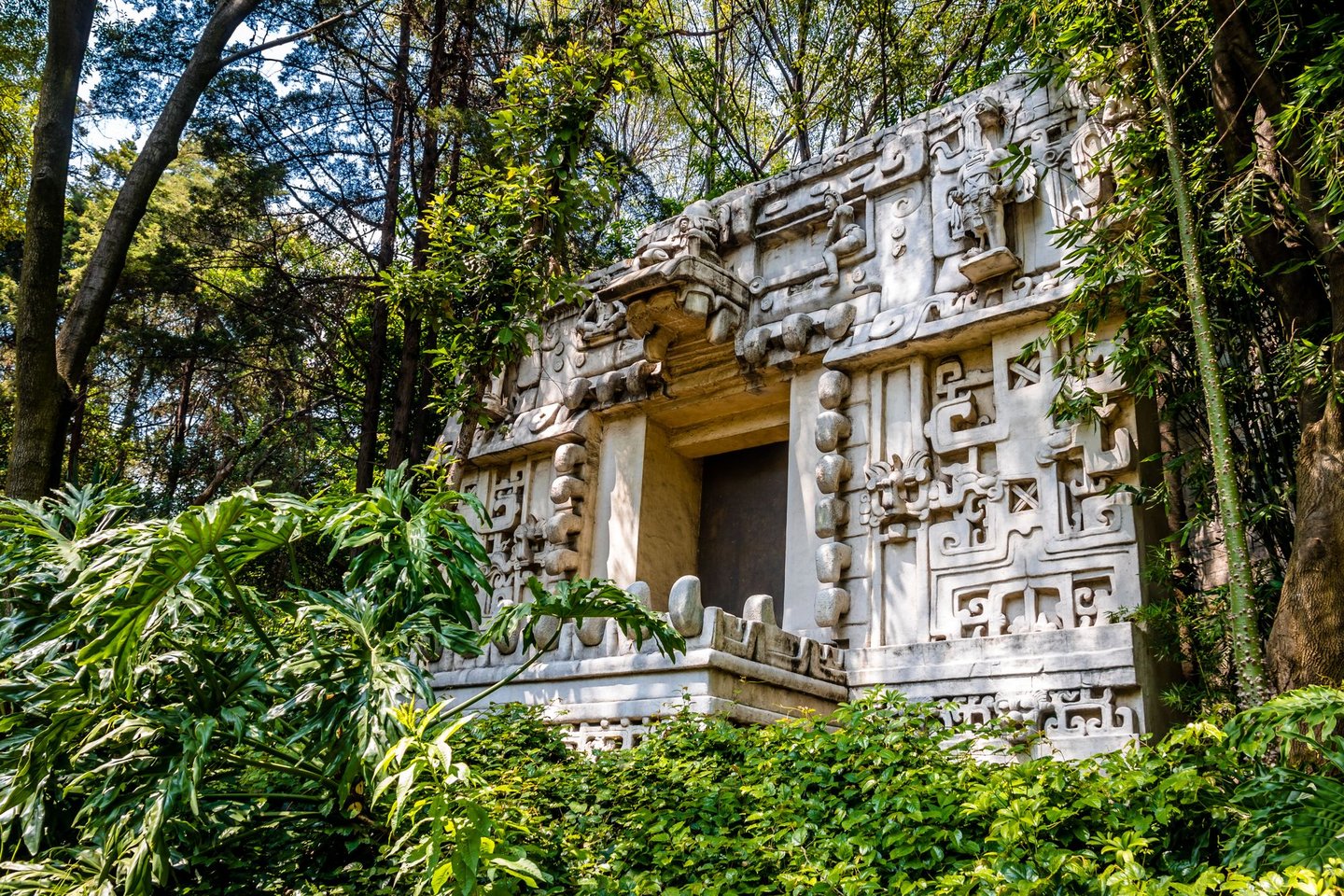 A Mayan temple surrounded by plants at the National Anthropology Museum in Mexico City