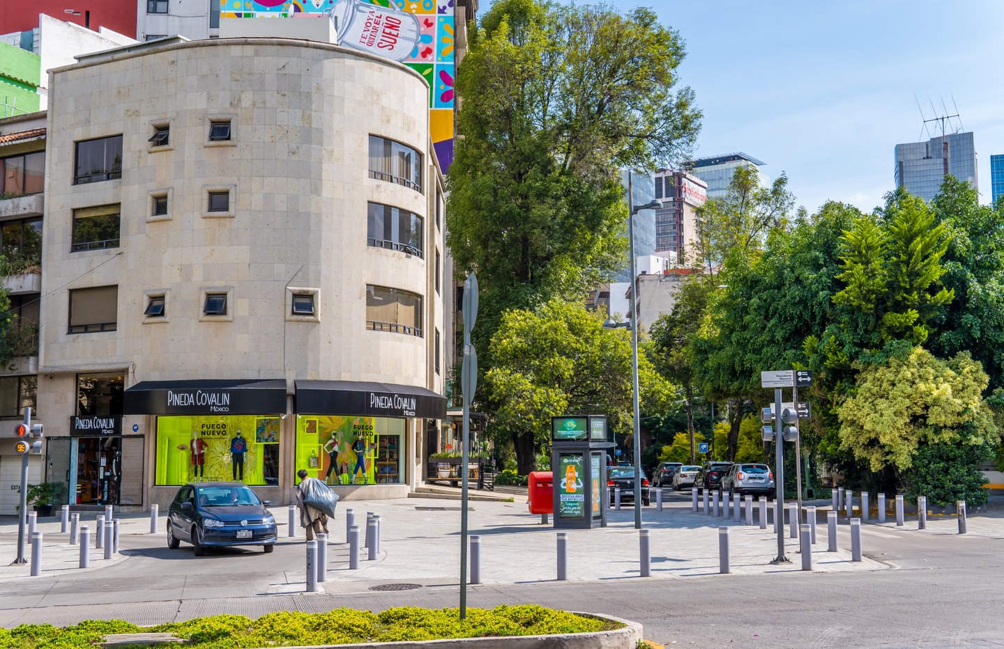 A street corner in Polanco, Mexico City, with buildings, cars and trees