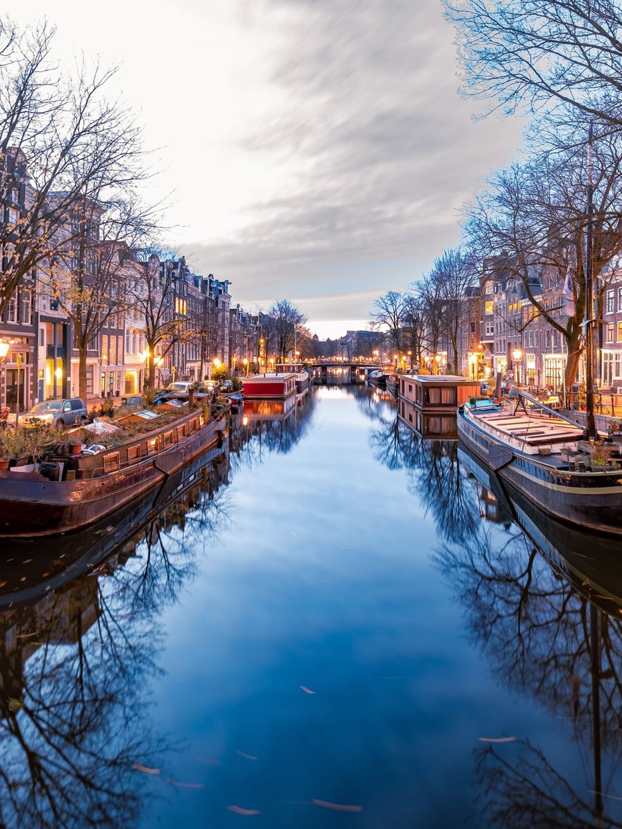 Boats on an Amsterdam canal on a winter evening