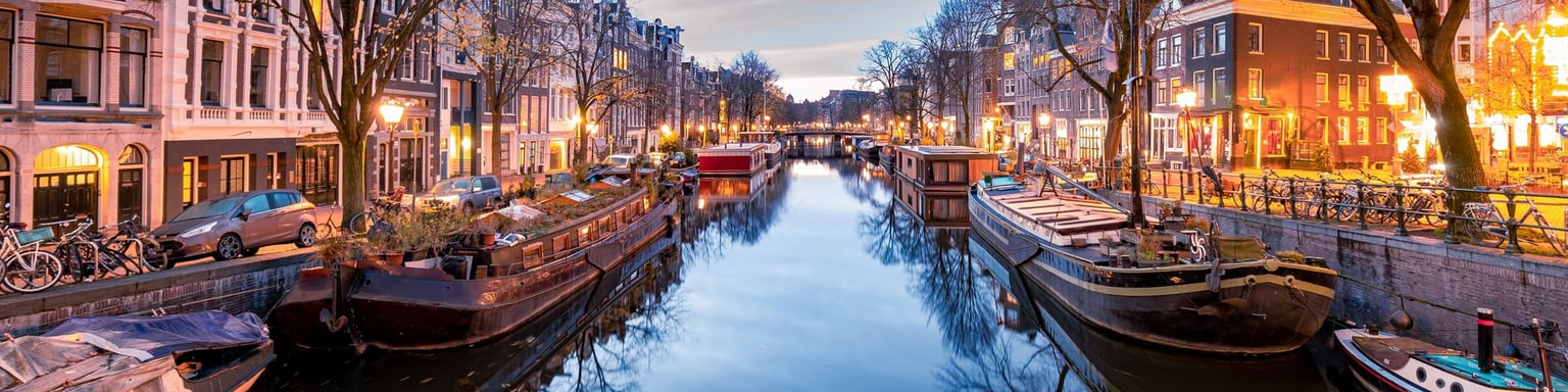 Boats on an Amsterdam canal on a winter evening