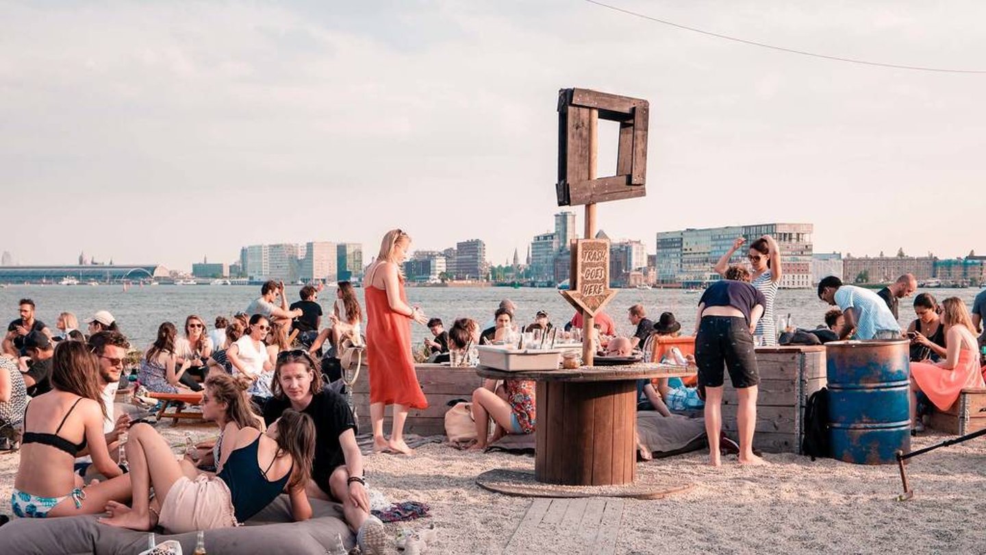 Young people relaxing on the waterfront in Amsterdam Noord