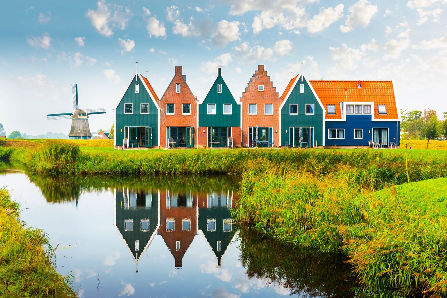 Colourful wooden houses and a windmill in Volendam, the Netherlands