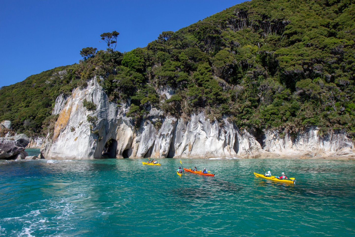Kayaking along the rocky coastline of Abel Tasman National Park