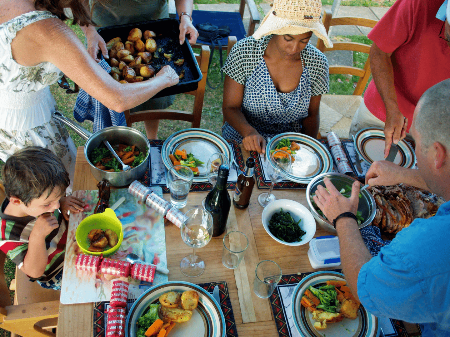 A family enjoying a roast meal for Christmas lunch in New Zealand