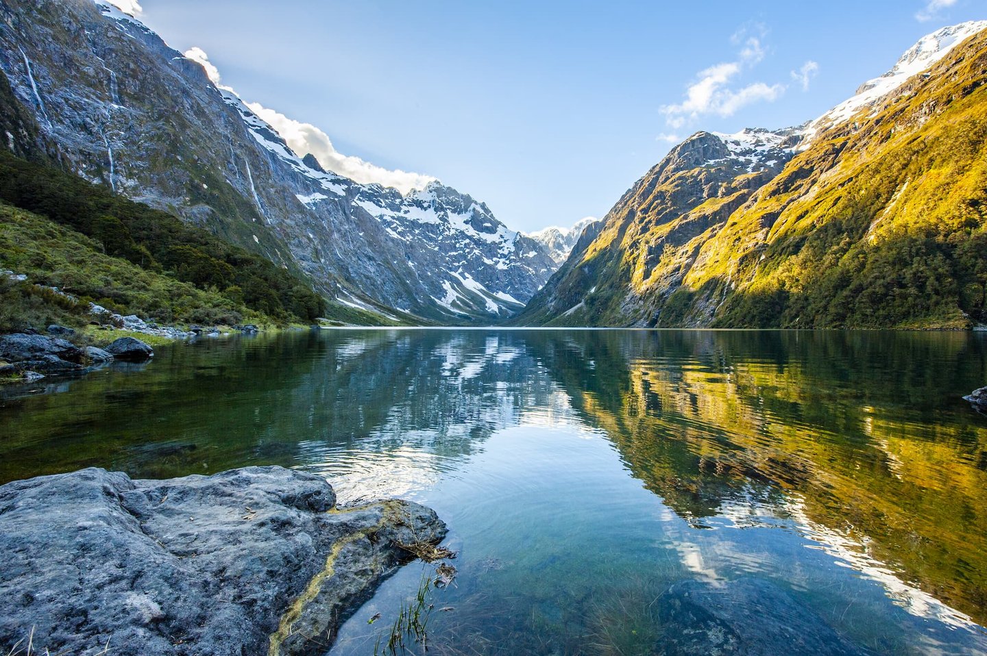 Peaks of Darran Mountains reflecting in Lake Marian, Fiordland national park, New Zealand