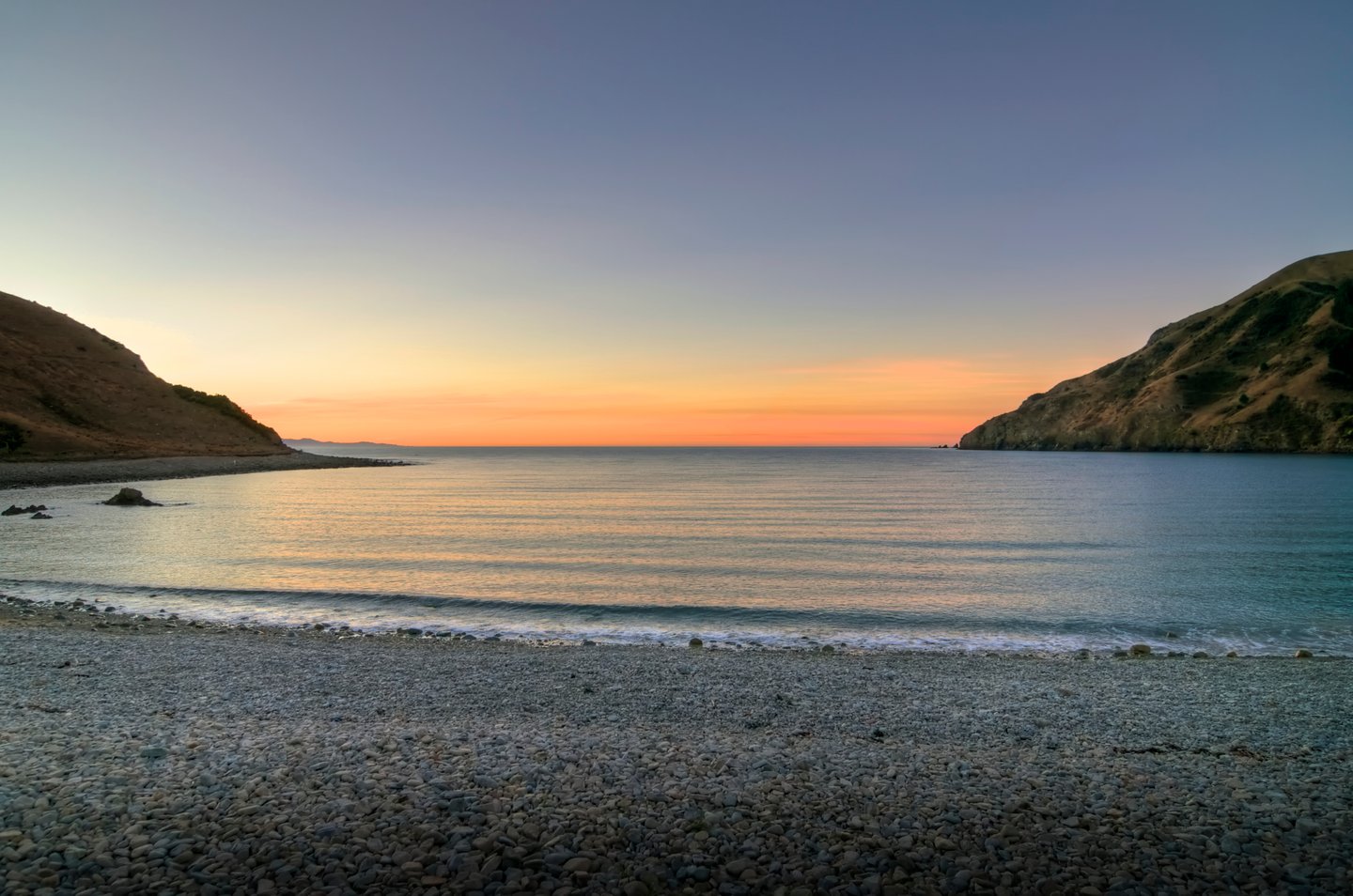 The sun setting over Cable Bay in Nelson, New Zealand