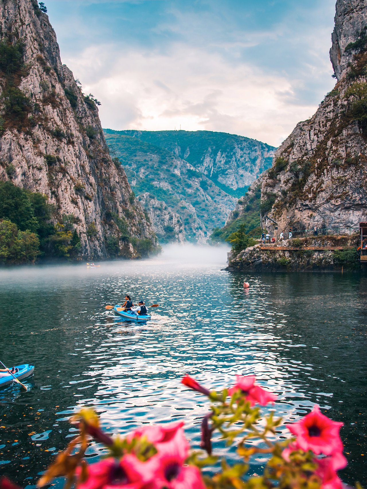 Canyon Matka near Skopje, with people kayaking and magical foggy scenery with calm water