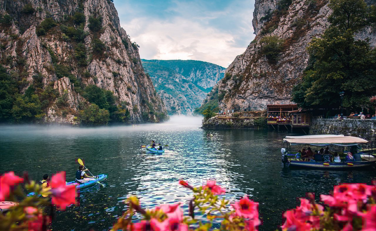 Canyon Matka near Skopje, with people kayaking and magical foggy scenery with calm water