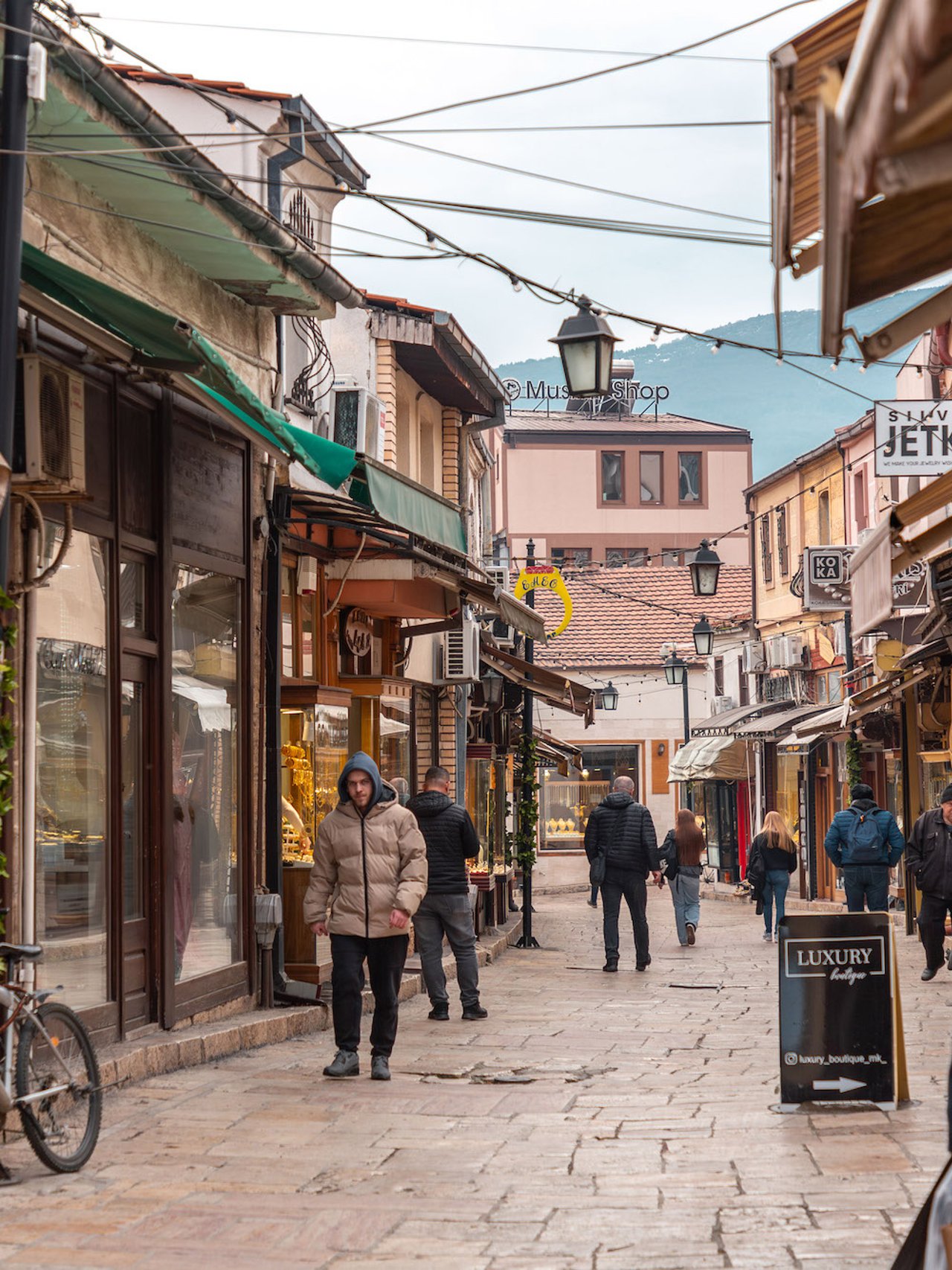 People walking down the streets of Skopje's Old Bazaar in winter