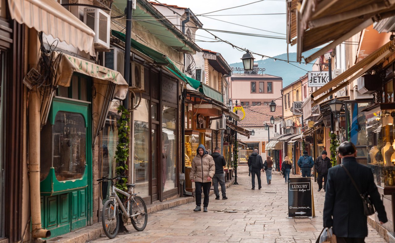 People walking down the streets of Skopje's Old Bazaar in winter