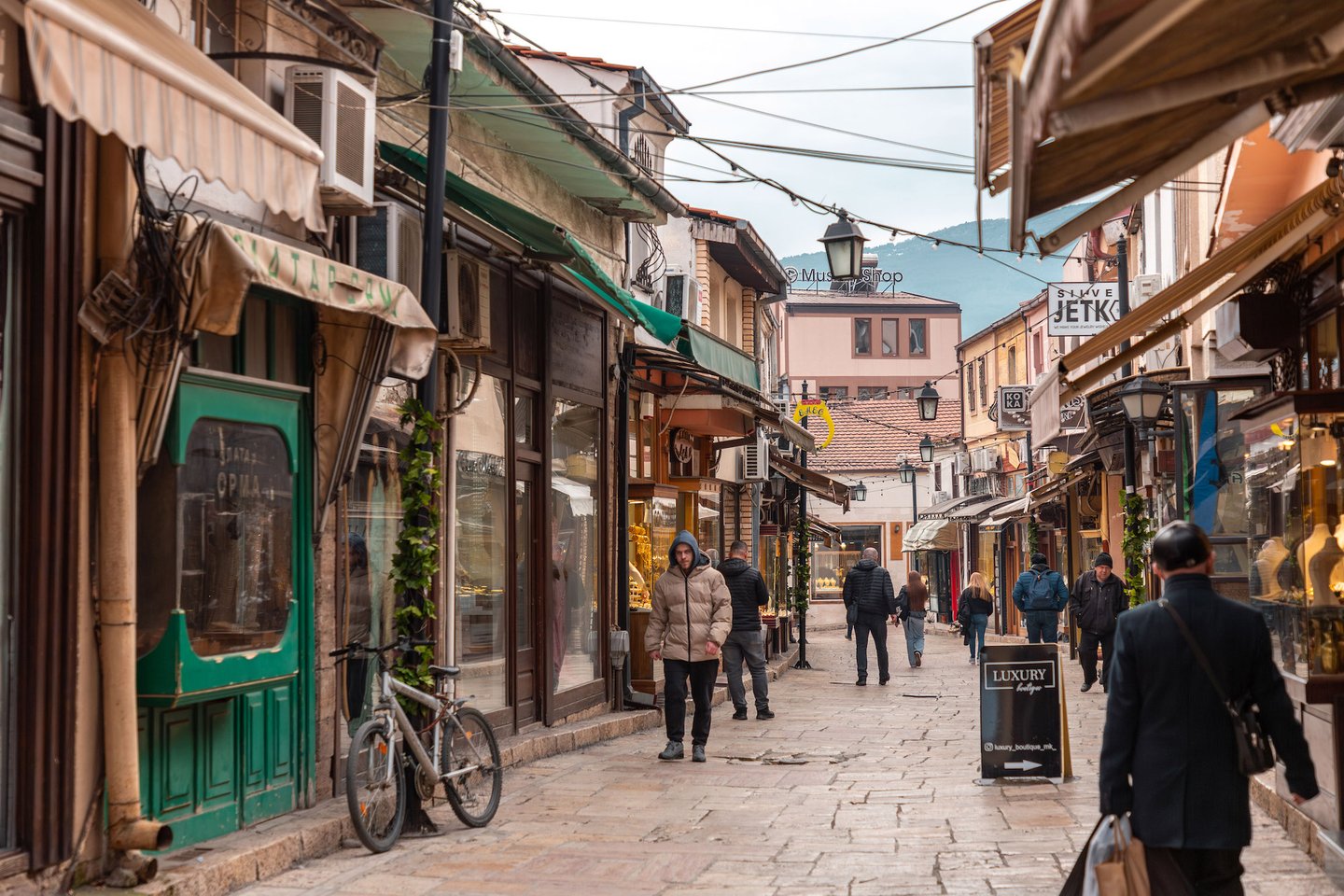 People walking down the streets of Skopje's Old Bazaar in winter